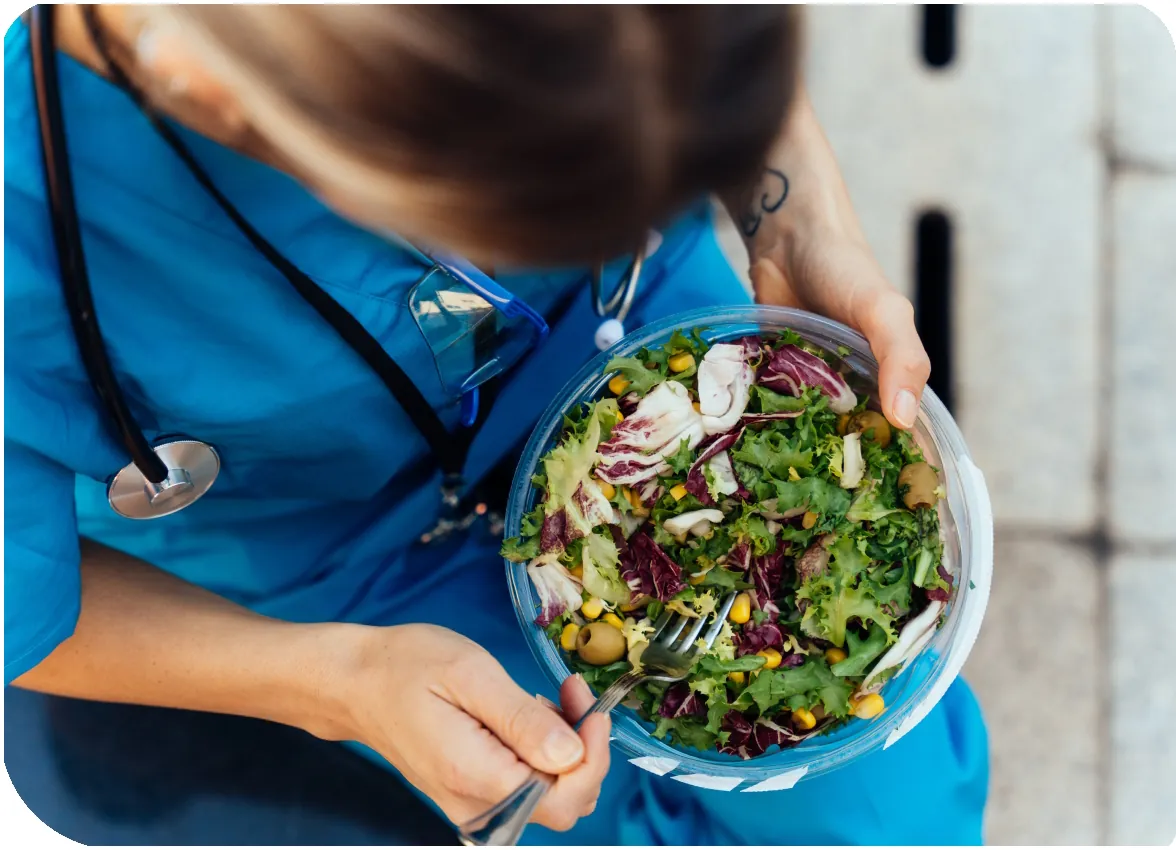 Nurse eating catered food on the job Hospital Catering