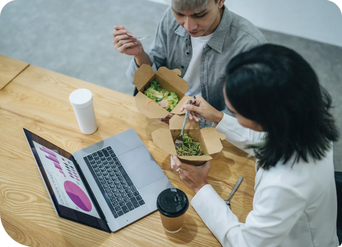 Two happy young asian having lunch over a meeting together. Pharma meeting catering